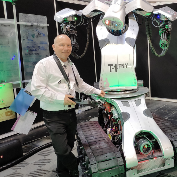 A photograph of Master Maker from Podpadstudios with their robot T1FNY